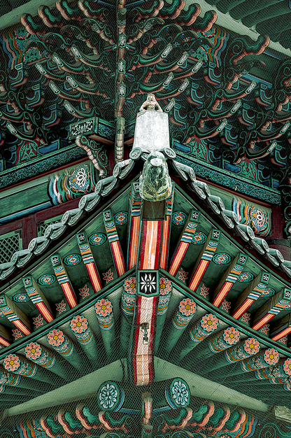 Fine Art Photography of monkey statue in traditional Korean temple architecture, Exhibit Limited Edition with vibrant roof details and depth.